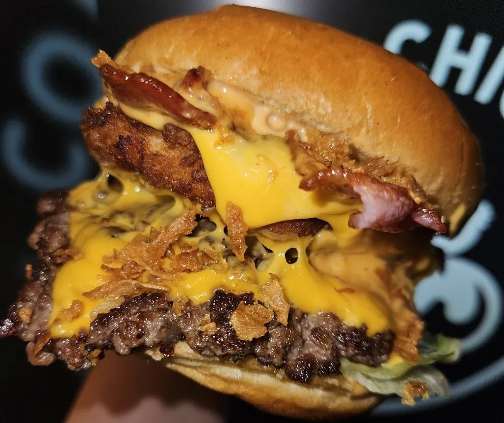 Cow and Chicken stacked burger with cheese and bacon